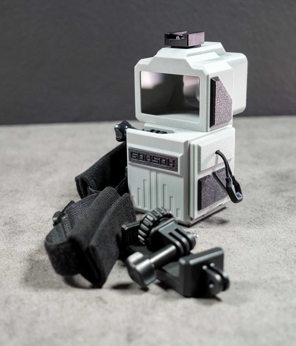 Mini 60 camera housing with included hand strap, phone mount and cold shoe adapter