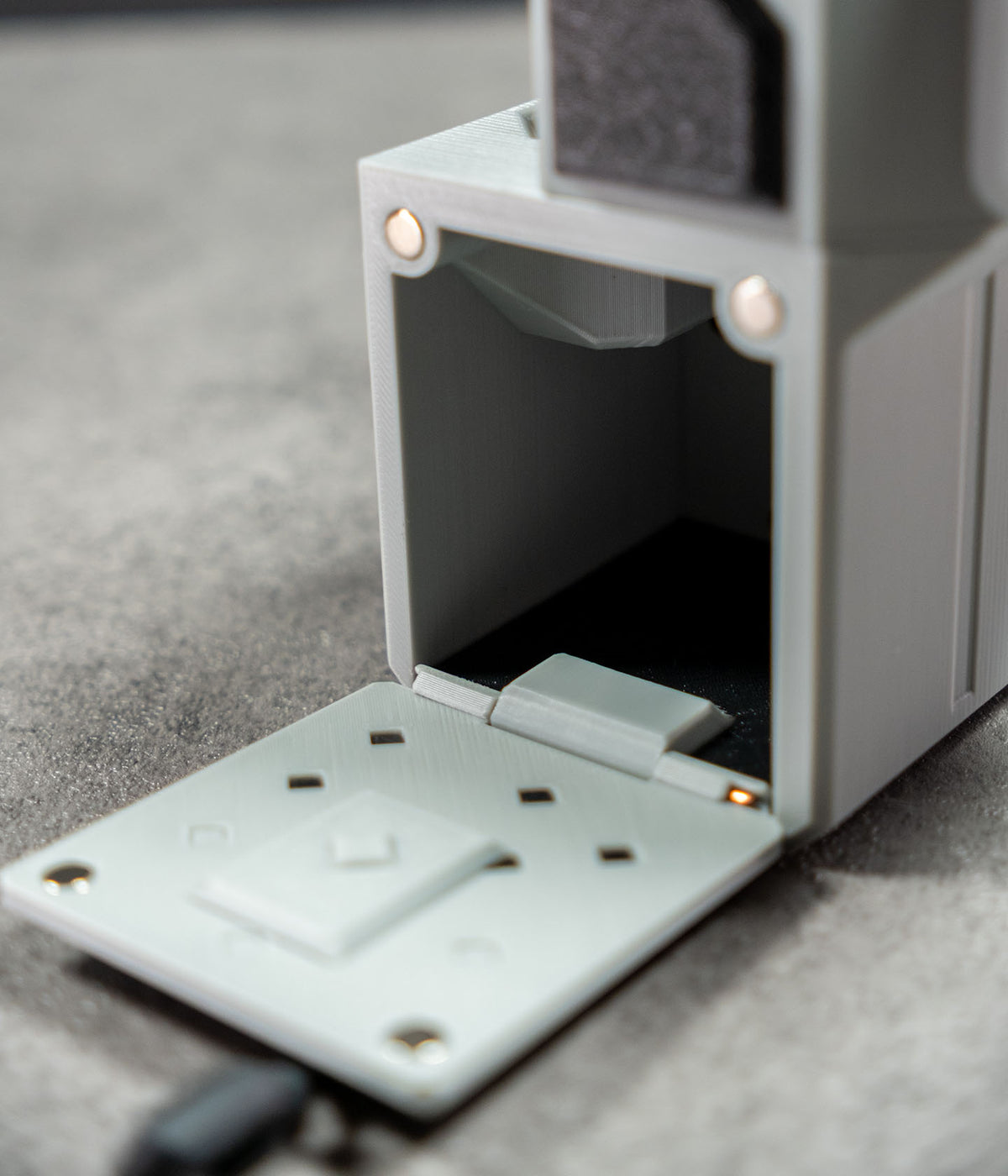 Mini 60 camera housing showing the open built-in side storage compartment
