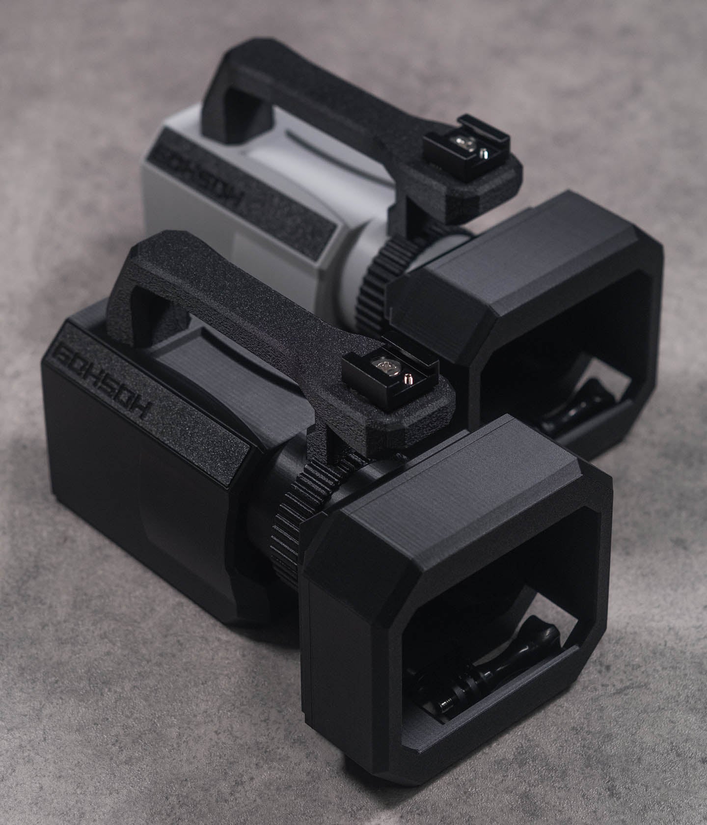 Mini VX™ 3D-printed action camera cage for GoPro, DJI Action and Insta360 — VX1000-style skate filming rig. Black and Grey Versions