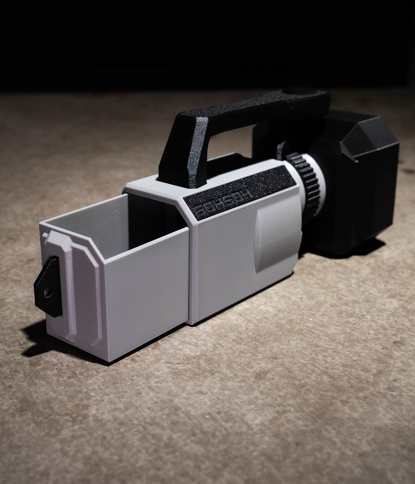 Rear slide-out accessory compartment on the Mini VX™ with cable passthroughs for charging or SSD recording.